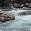 These guys were playing with fire as they slid down in the current. Esses caras estavam brincando com fogo ao deslizar na correnteza.
